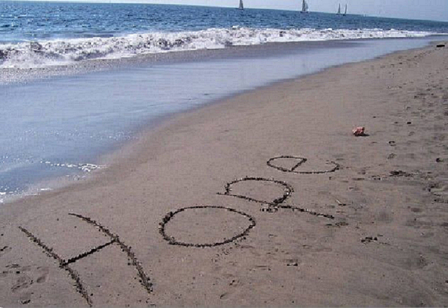 The word hope written in the sand at the beach