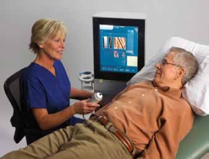 Picture of man getting fibroscanned by a woman technician 