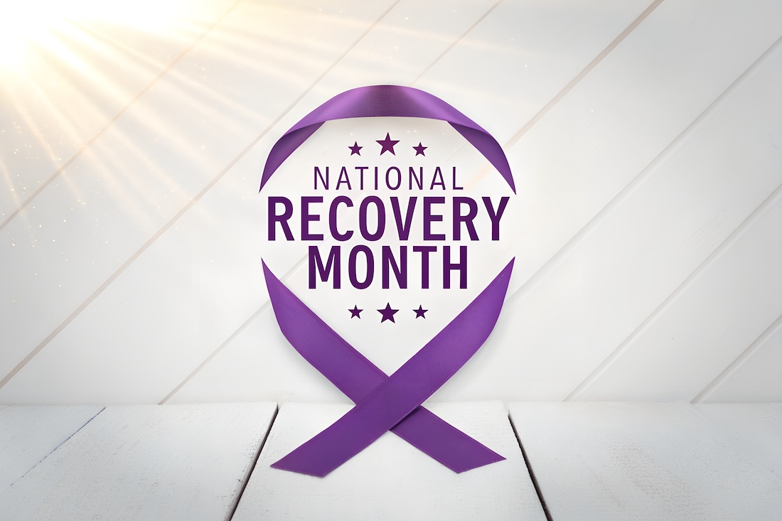 A graphic for National Recovery Month consisting of the title of the occasion inside of a purple ribbon