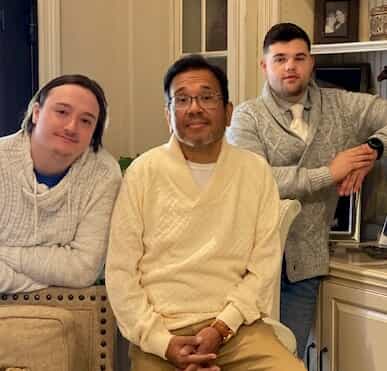 Magdaleno Jacquez III seated with two friends
